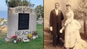A couple standing next to a grave marker.