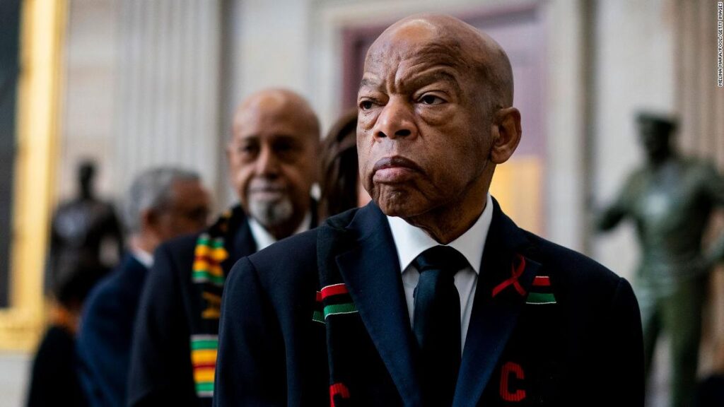 A man in a suit and tie standing next to another man.