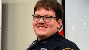 A police officer smiling for the camera.