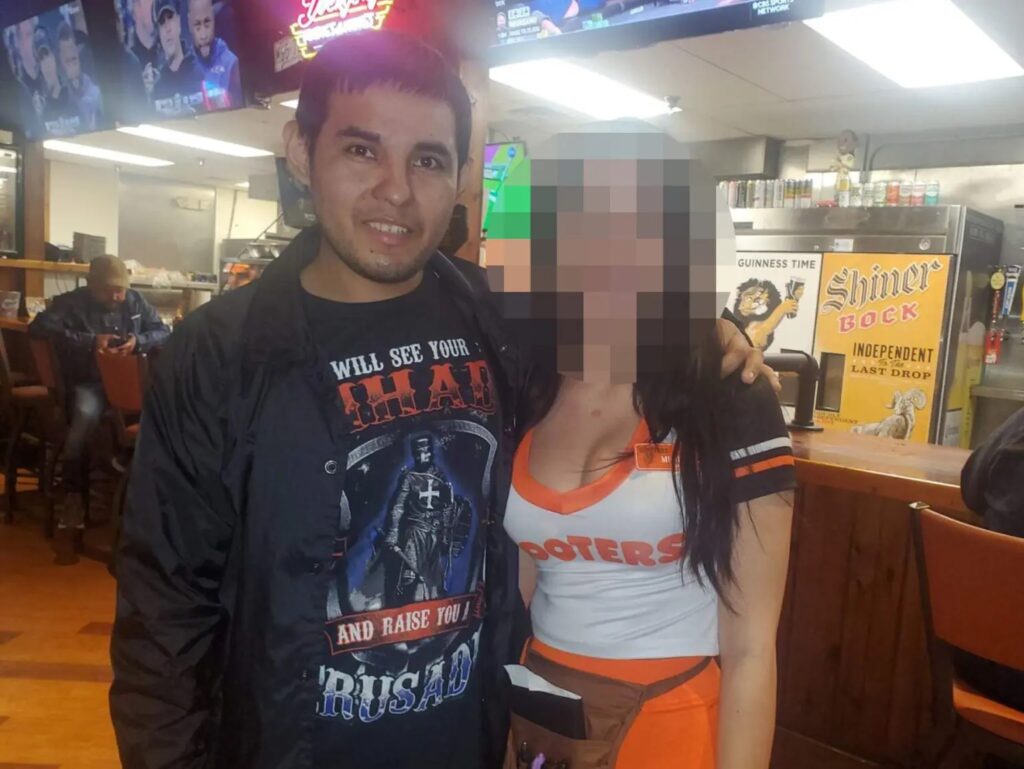 A Mall Gunman posing with a waitress