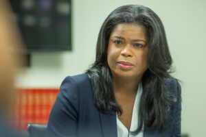 A woman in a suit sitting at a table.