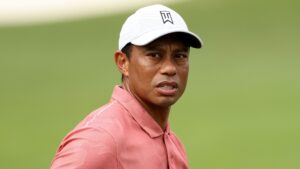 A close up of tiger woods wearing a hat