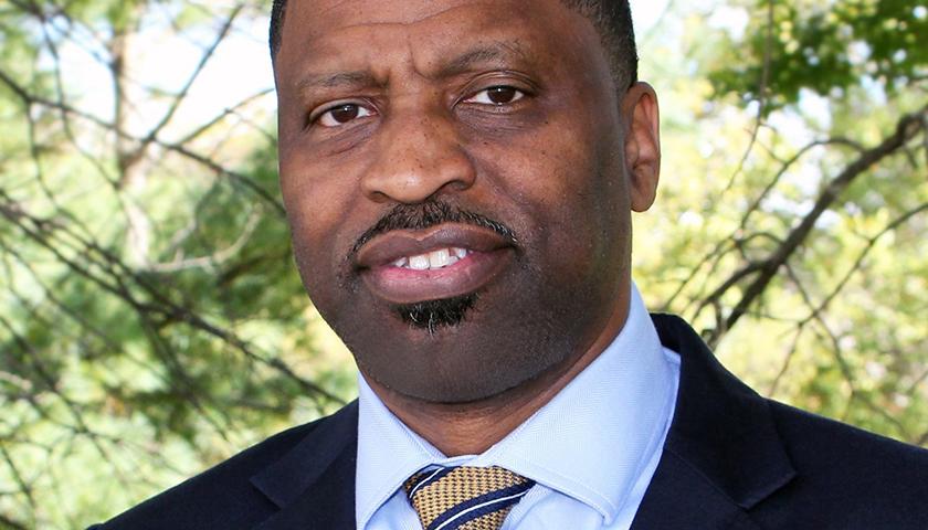 A man in a suit and tie standing outside.