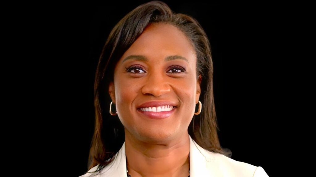 A woman with long hair and a white jacket.