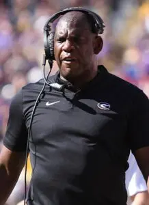 Head coach wearing black headset and black shirt.