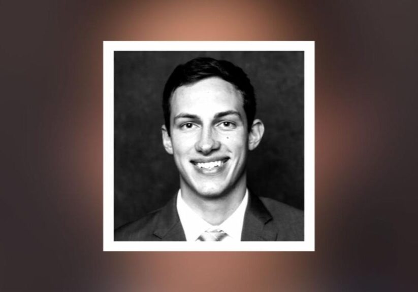 A black and white photo of a man in suit