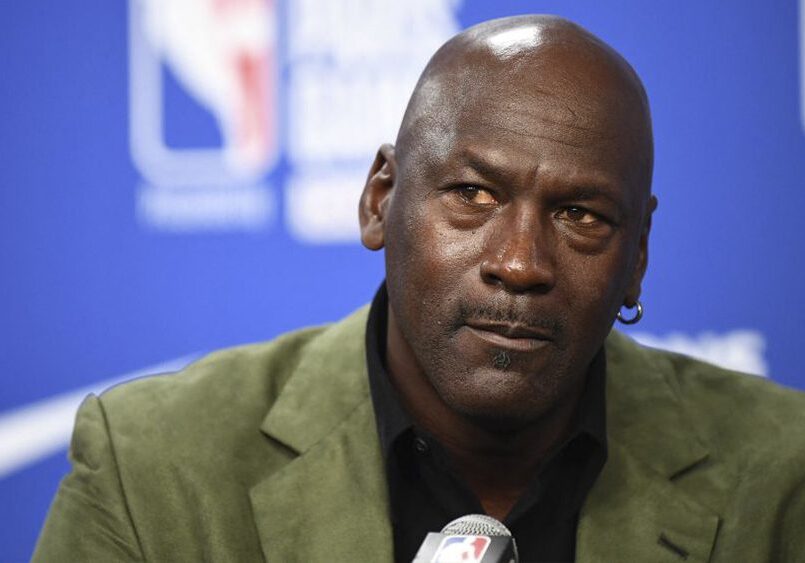 A close up of michael jordan wearing a green jacket