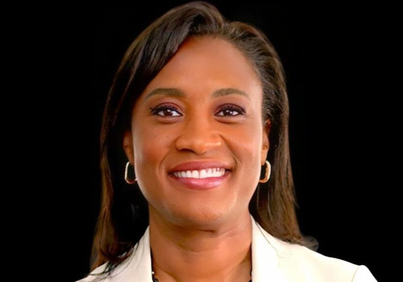 A woman with long hair and a white jacket.