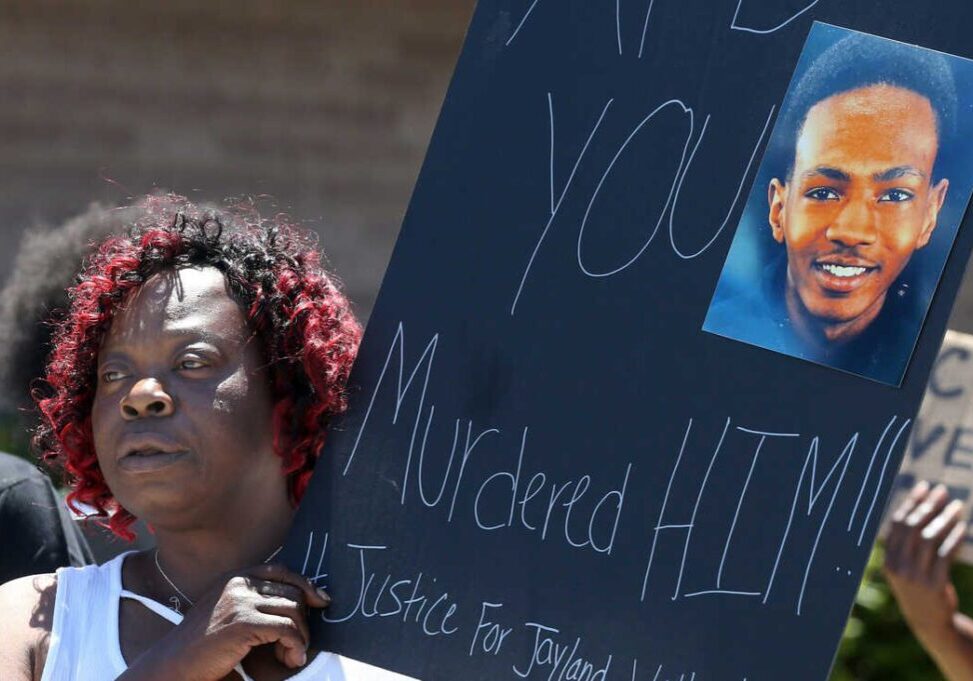 FILE - Lynnette Williams holds a sign during a gathering at Second Baptist Church on July 2, 2022, in Akron, Ohio, calling for justice for Jayland Walker. Walker, a 25-year-old Black man killed in a hail of police gunfire in Akron last month, was shot or grazed 46 times, according to a preliminary autopsy report released Friday, July 15, 2022, by the Medical Examiner's Office in Summit County. (Phil Masturzo/Akron Beacon Journal via AP)